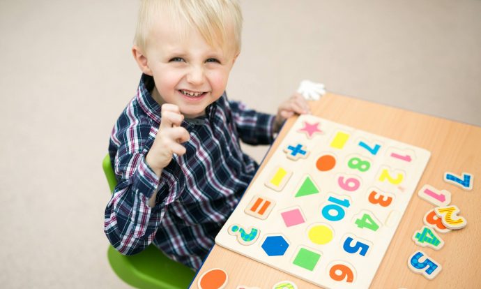 little boy playing nursery jigsaw